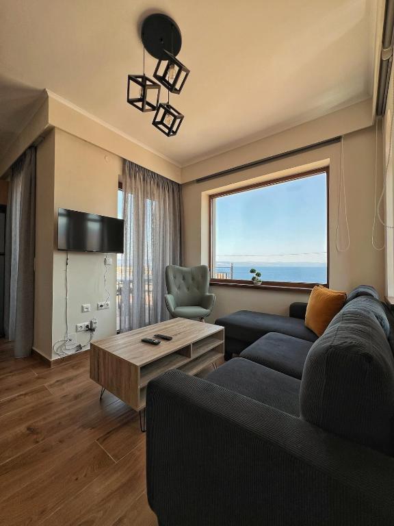 a living room with a couch and a table at Endless View 2 in Mythimna