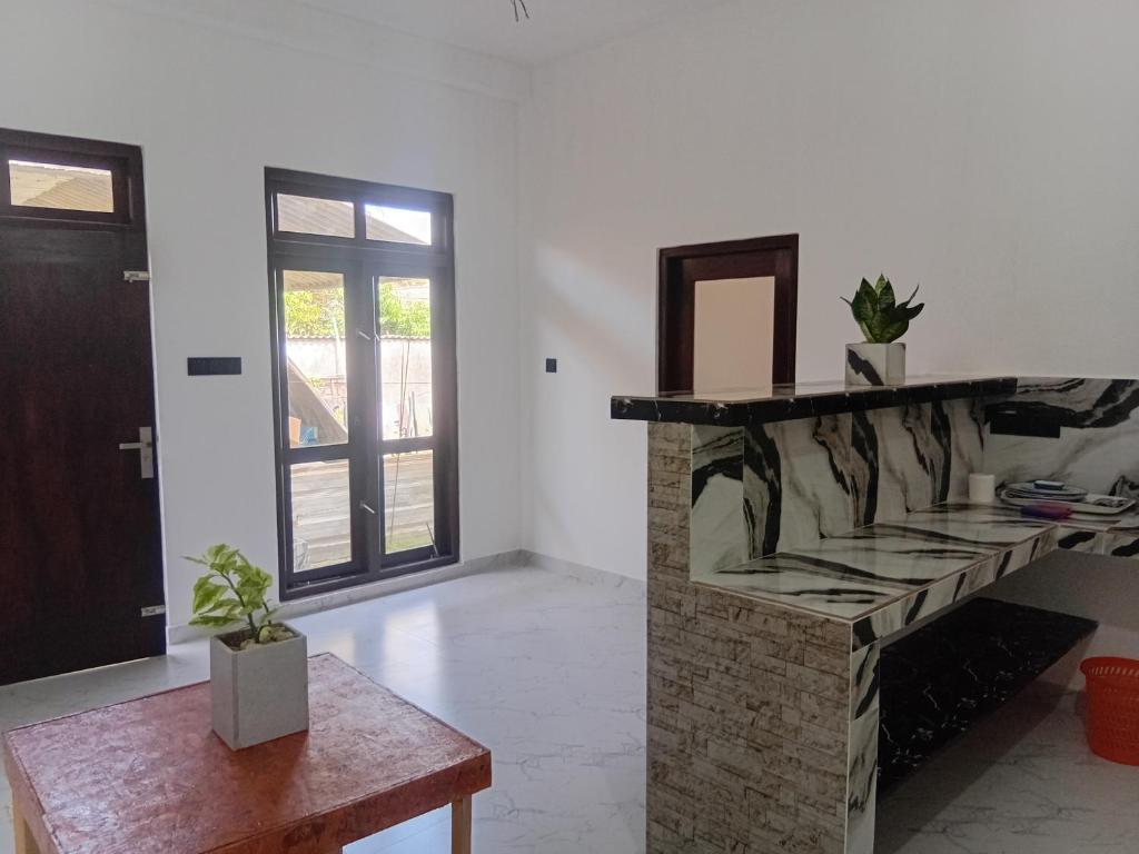a room with a counter with a mirror and a table at Nikita Homestay in Kosgoda