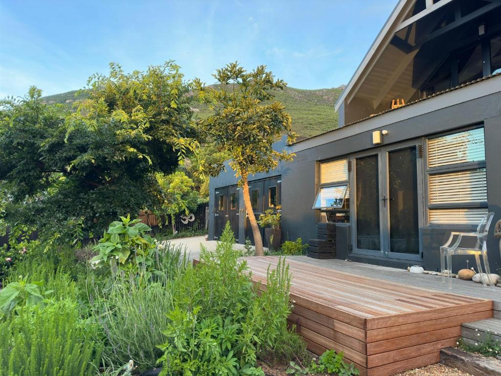 a wooden deck in front of a house at Noordhoek Wellness Pilates in Noordhoek