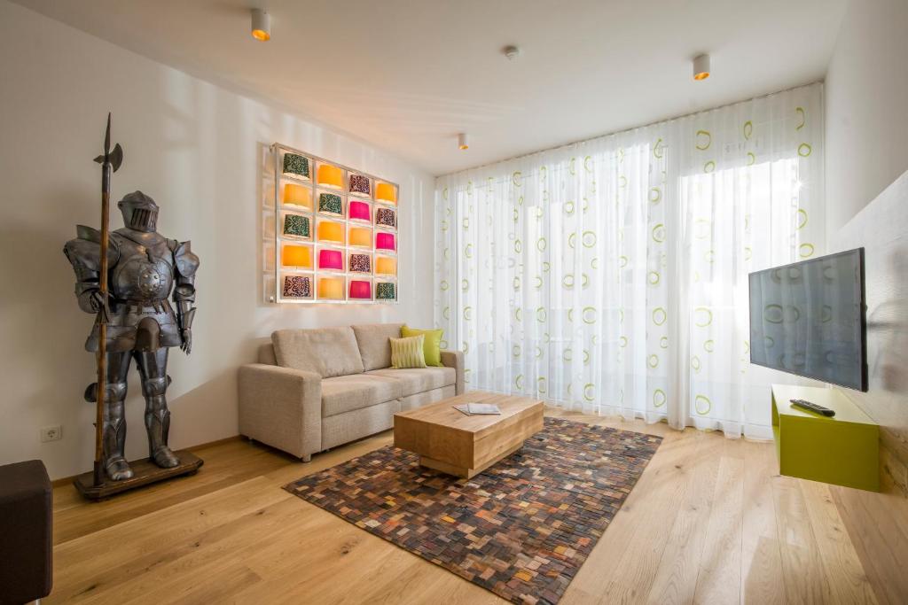 a living room with a statue of a man at Private Living Apartments in Kufstein