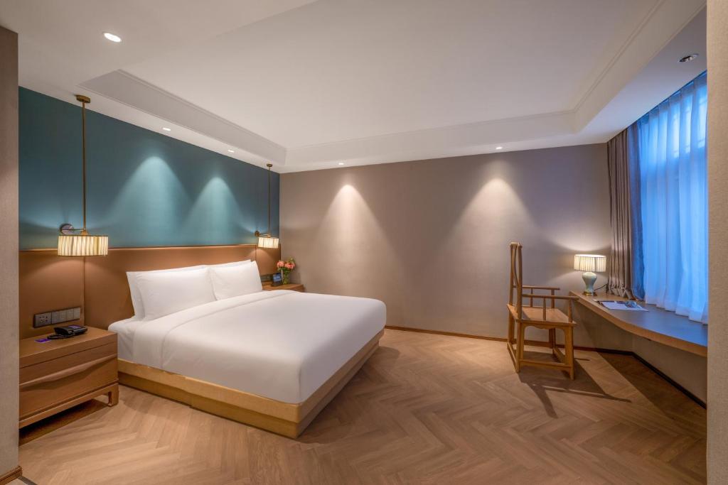 Postel nebo postele na pokoji v ubytování Qingdao Xinduxin Manxin Hotel