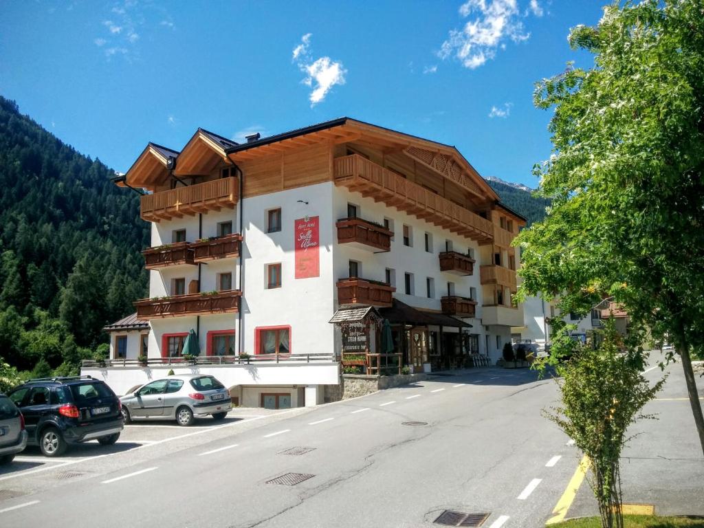a large building on the side of a street at Sport Hotel Stella Alpina in Cogolo
