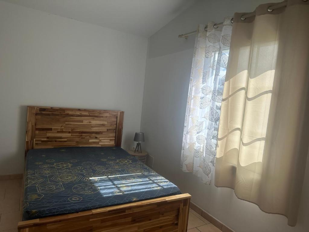 圣皮埃尔Villa Corbeil的一间带床和窗户的小卧室