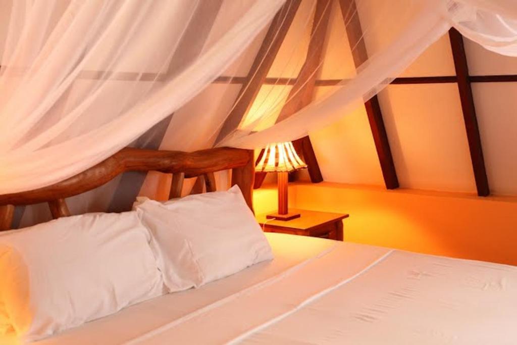 Postel nebo postele na pokoji v ubytování Sunset Villa Boutique Resort