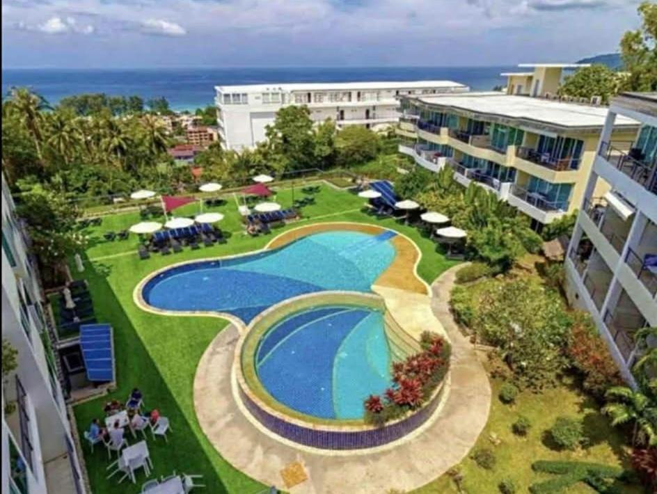 an aerial view of a resort with a swimming pool at Karon Butterfly Phuket in Ban Karon