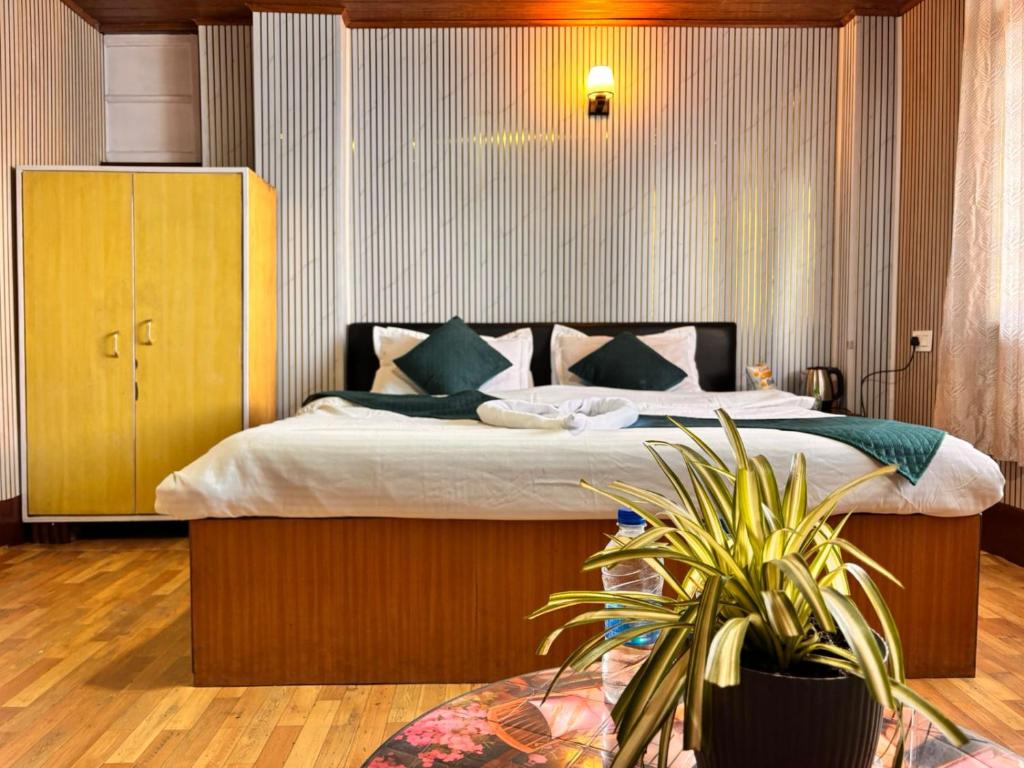 een slaapkamer met een groot bed in een kamer bij P Square Resto Cafe n Stay in Darjeeling