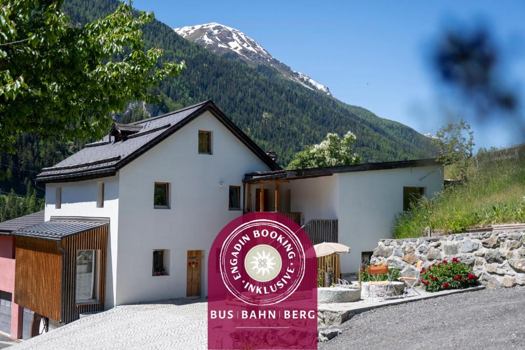 a building with a bus barn beef sign in front of it at Studio Nuna EG in Ardez