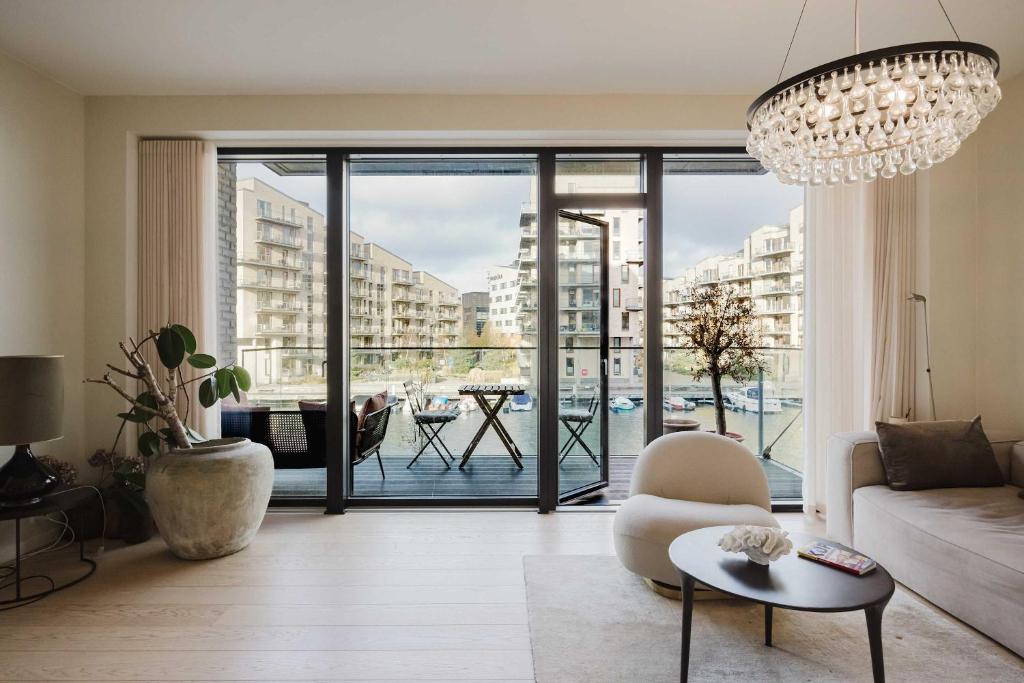a living room with a couch and a chandelier at Water Front View - Prime Apartment in Copenhagen
