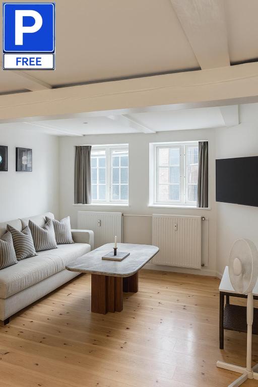 a living room with a couch and a table at LD Central Lejlighed Odense C in Odense