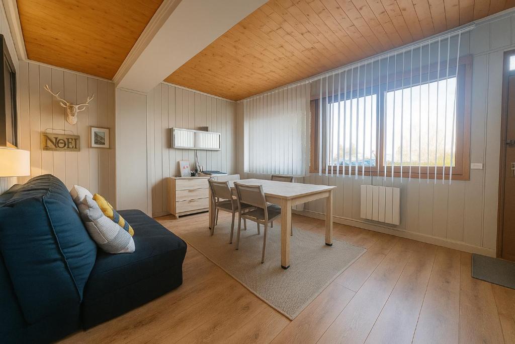a living room with a table and a couch at White Lodges - Megève center on ski slopes in Megève