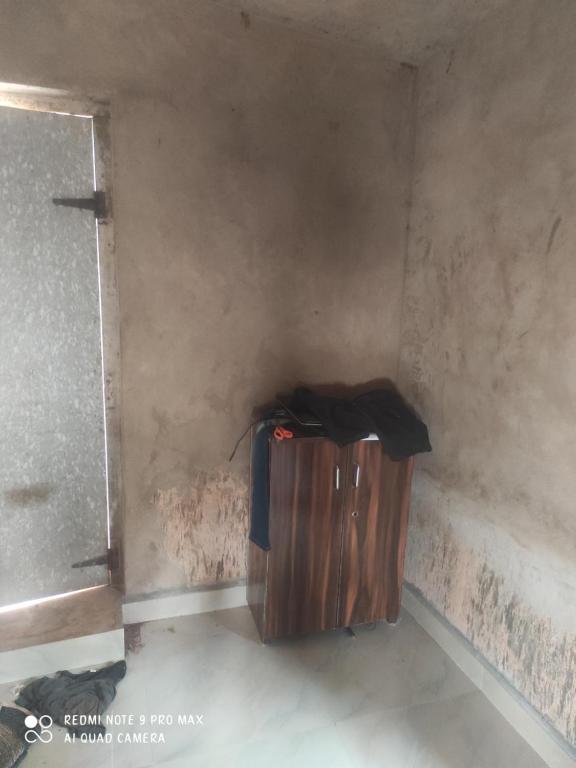 a trash can in a corner of a room at House in Mirjān