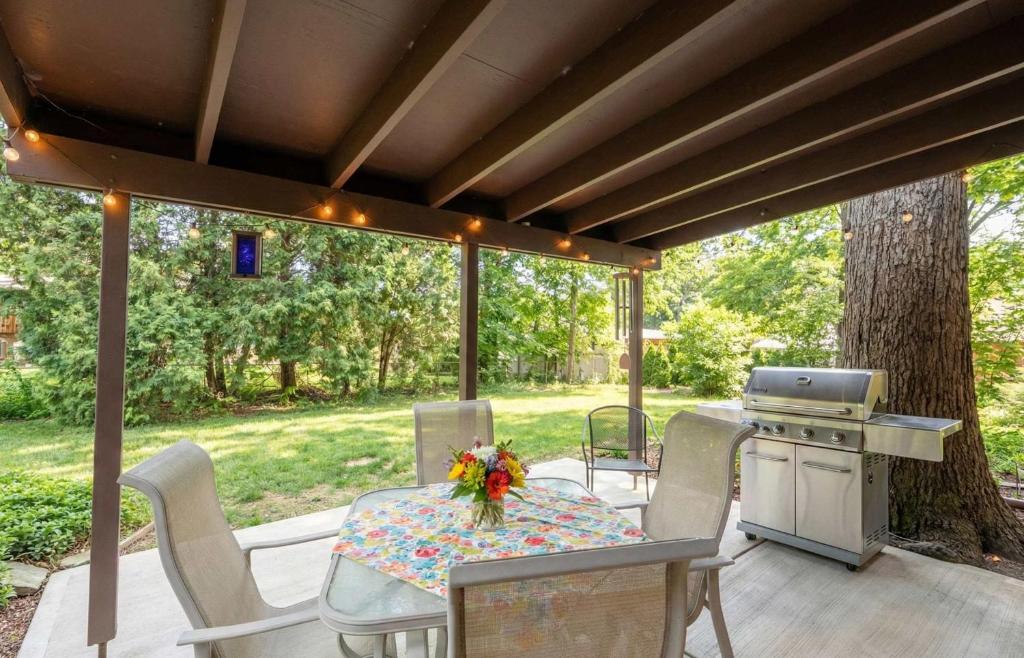 a patio with a table and chairs and a grill at Spacious 4BR Home with BBQ Yard Near Golf Course in Rockford