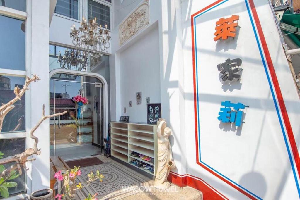 a room with a white wall with a glass door at 萊家莉民宿 in Xiaoliuqiu