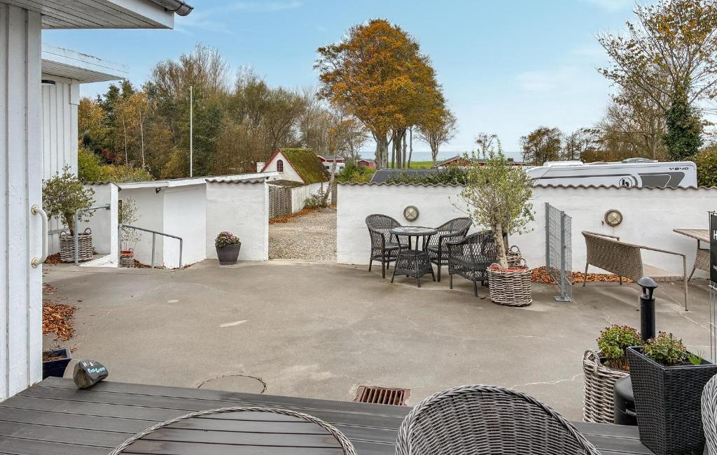 a patio with chairs and a table in a backyard at 1 Bedroom Beautiful Home In Samsø in Kolby Kås