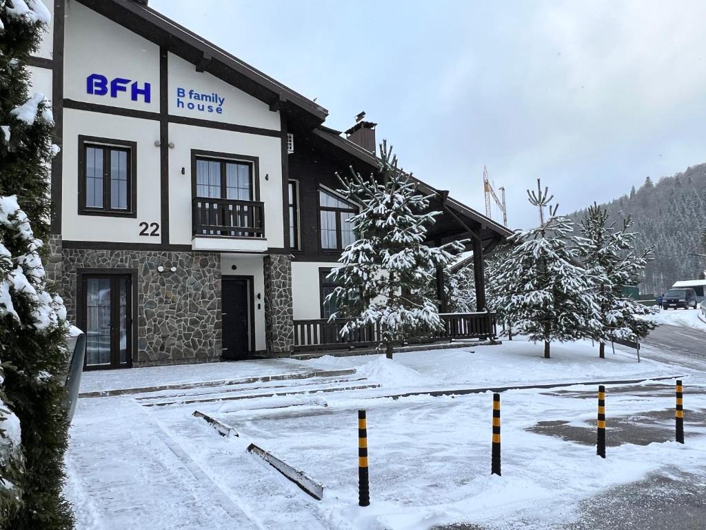ein Gebäude mit Schnee auf dem Boden davor in der Unterkunft Chalet BFamilyHouse Bukovel in Bukowel