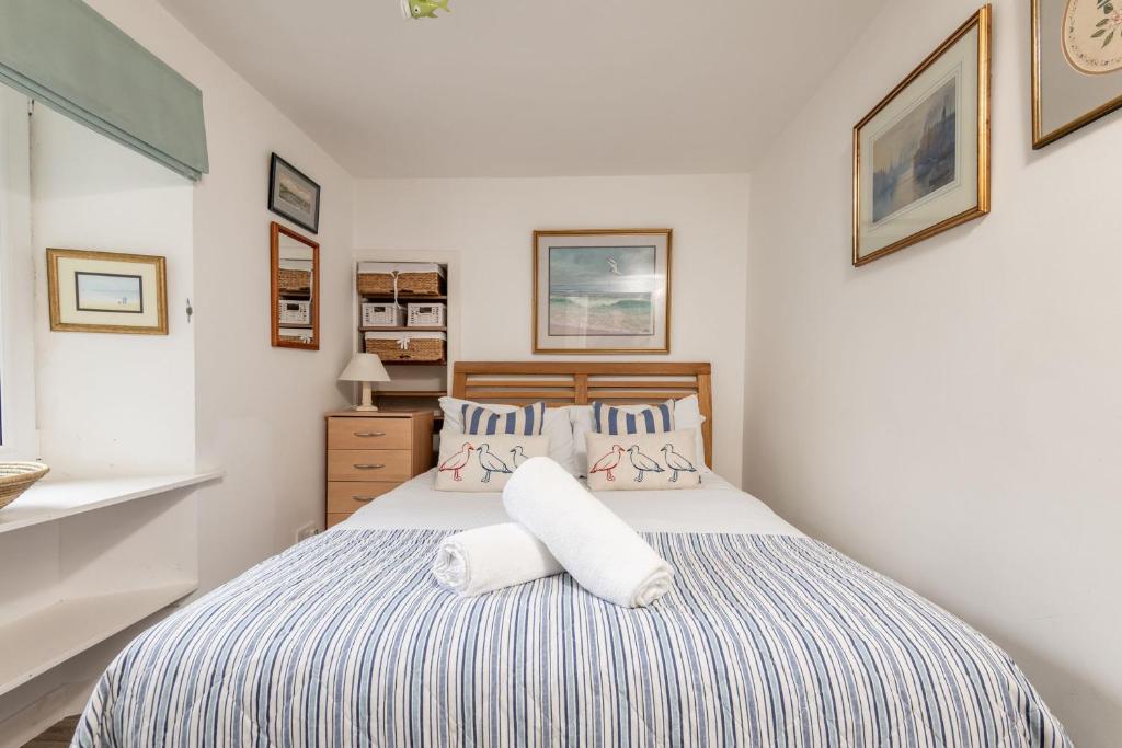 a bedroom with a bed with two pillows at The Mini Mansion - Elie in Elie