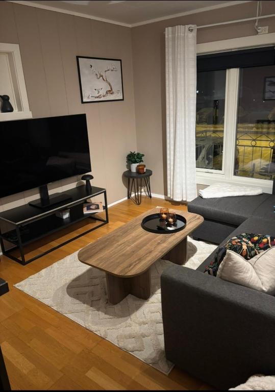 a living room with a couch and a coffee table at Strandveien apartment in Narvik