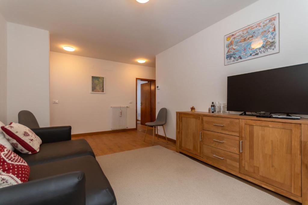 a living room with a large flat screen tv at Sweet Loft in Sottoguda