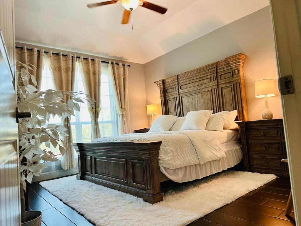 a bedroom with a large bed with a wooden headboard at Welcome to enjoy your home in Dallas