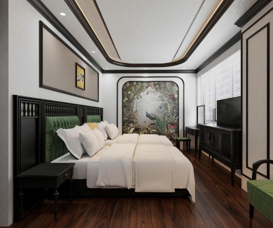 a bedroom with a large white bed and a tv at Royal Hotel Lâm Hạ in Hanoi