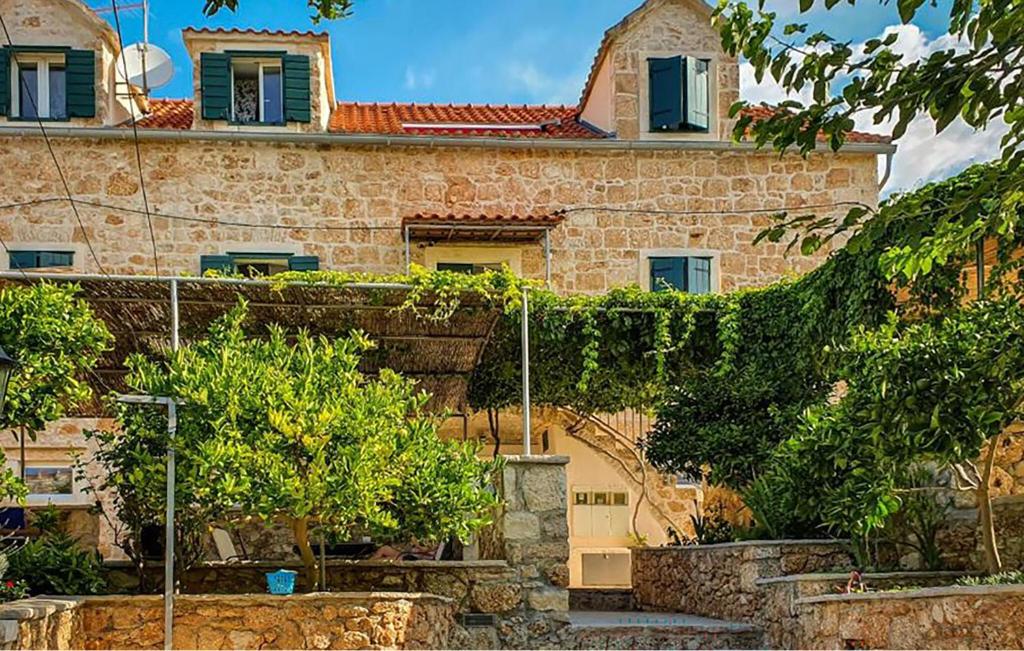 Pet Friendly Apartment In Bol With Wifi في بول: مبنى حجري كبير امامه اشجار