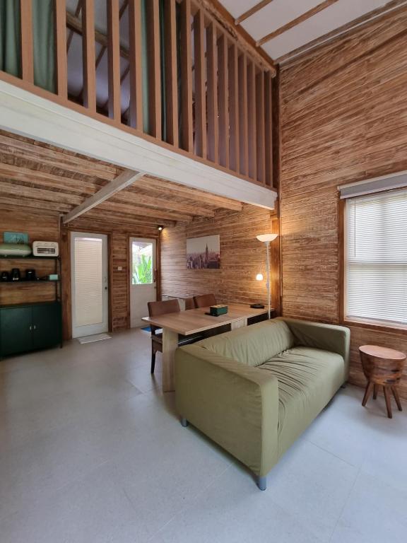 a living room with a couch and a table at Tiny House Bali in Kerobokan