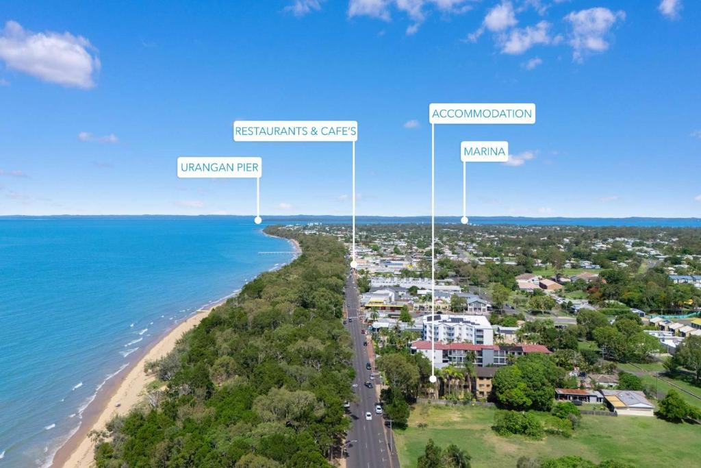 an aerial view of a beach with three towers at Esplanade Charm Apartment in Torquay