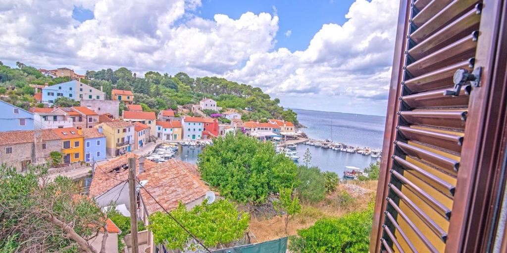 a view of a town on a hill next to the water at Antunovic in Veli Lošinj