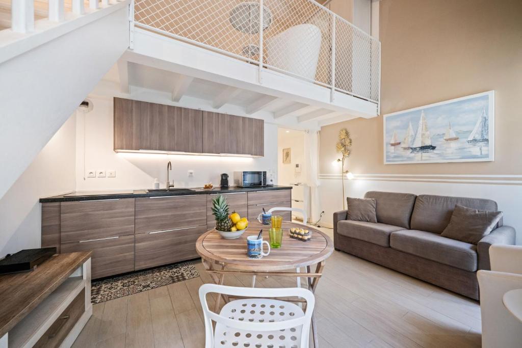 een woonkamer met een bank en een tafel bij Villa Carla - Hyper Centre - Climatisation - Wifi in Menton