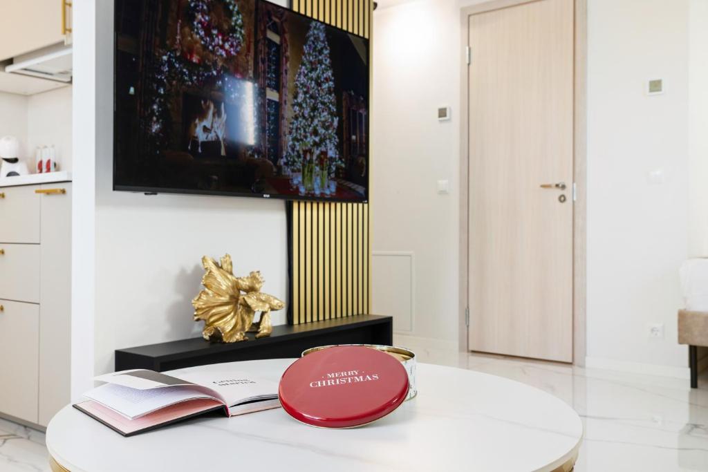 a room with a table with a book on it at F-Apartments - River view, Contactless in Tartu