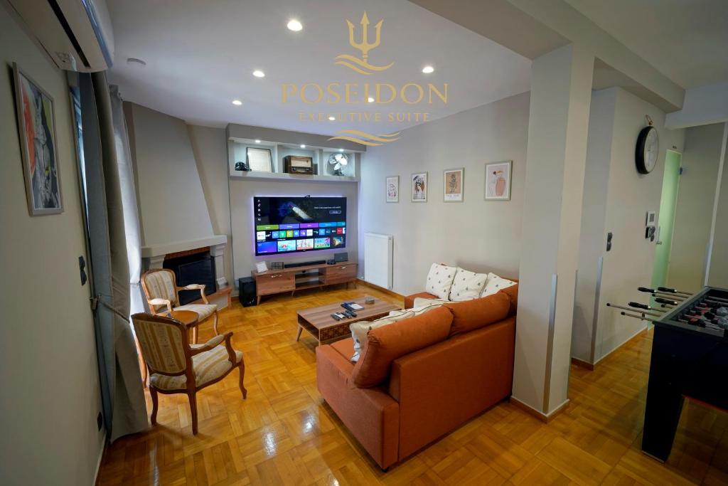 a living room with a couch and a tv at POSEIDON Executive Suite in Athens