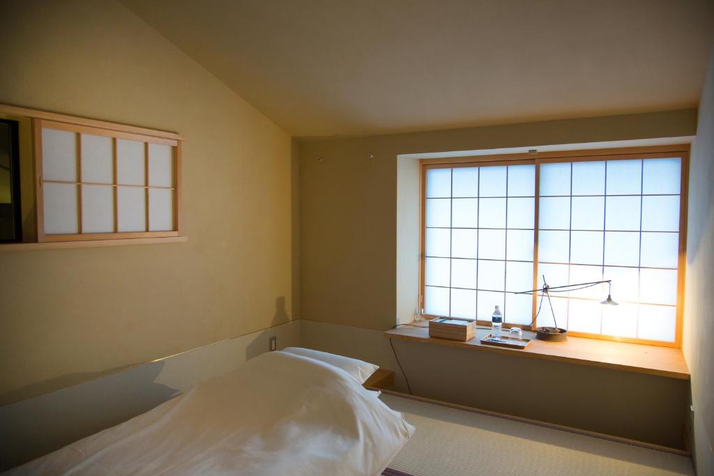 Postel nebo postele na pokoji v ubytování Ryokan Mugen (Adult Only)