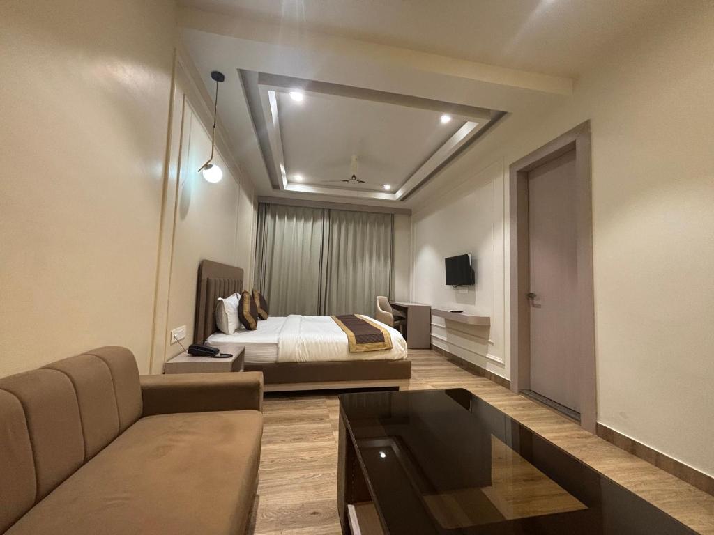 a hotel room with a bed and a couch at Hotel Shree Rajasthan Inn in Ajmer