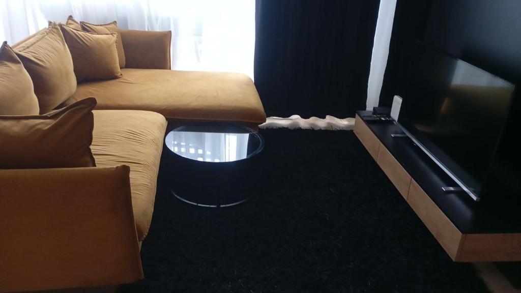 een woonkamer met een bank en een tafel bij Golden Ząbkowska A in Dobrovelychkivka