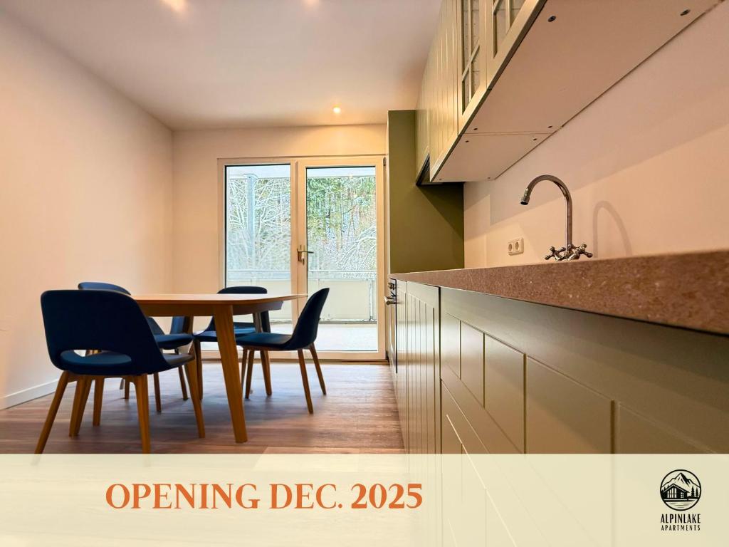 a kitchen with a table and chairs and a sink at Treehouse - Alpinlake Apartments in Grünau im Almtal