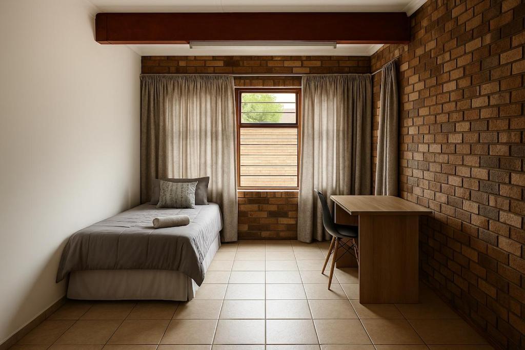 a bedroom with a bed and a desk and a window at Spacious 7 bedroom house with pool and jacuzzi in Johannesburg