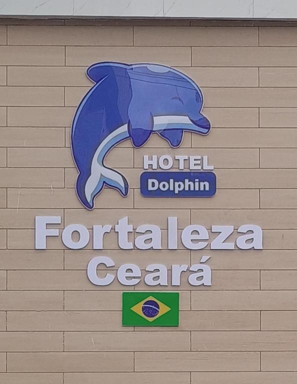 a sign for a hotel dolphineria center on a wall at Hotel Dolphin Fortaleza in Fortaleza