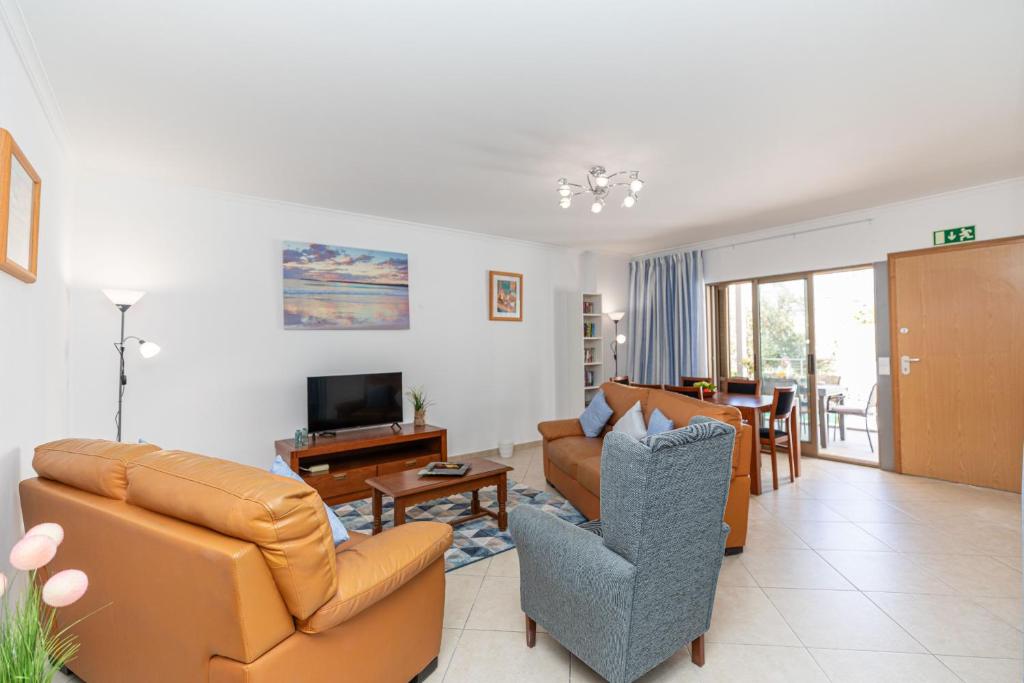 a living room with a couch and chairs and a television at Apartment Atlantico, Town Centre in Tavira