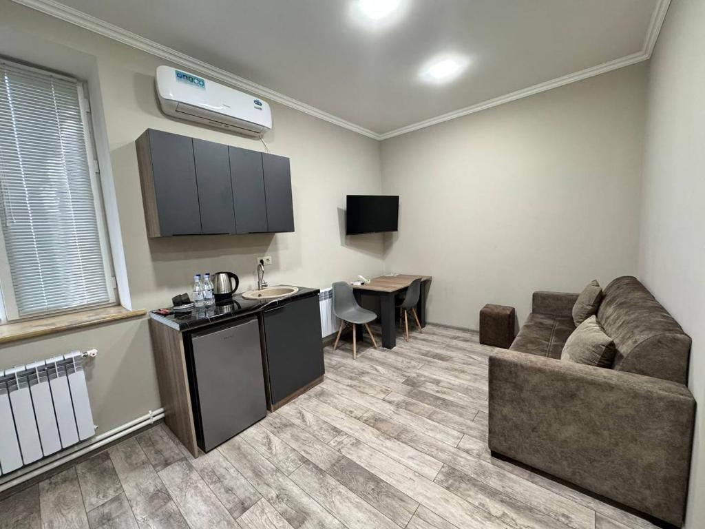 a living room with a couch and a table at Bank Hotel in Yeghegnadzor