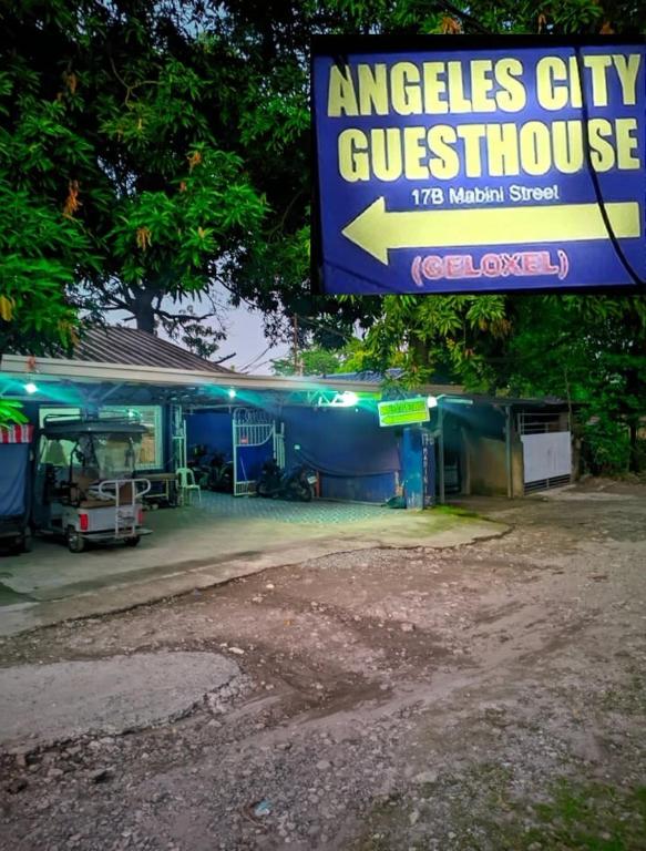 a building with a sign for an angels city guest house at GELOXEL Angeles City Guesthouse in Angeles