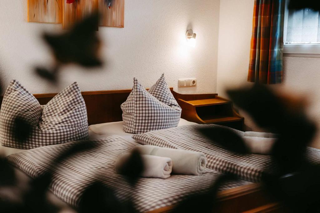 a blurry picture of a bed with pillows at Pension Adler in Sonthofen