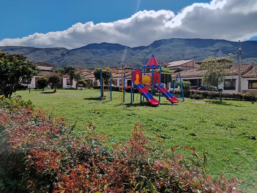 a playground in a park with mountains in the background at Villa Girasol in Villa de Leyva