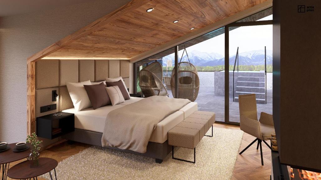 a bedroom with a large bed and a balcony at Hotel am Hopfensee in Füssen