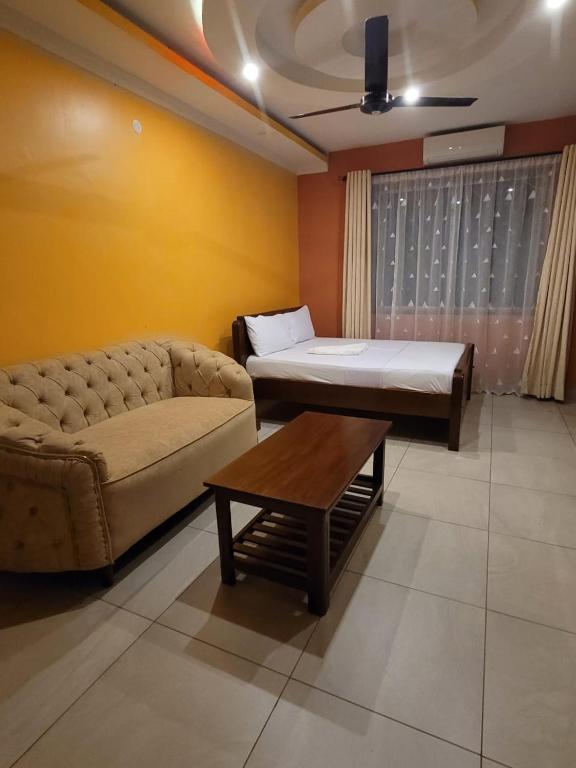 a living room with a couch and a bed at Seko Haven Resort in Kilifi
