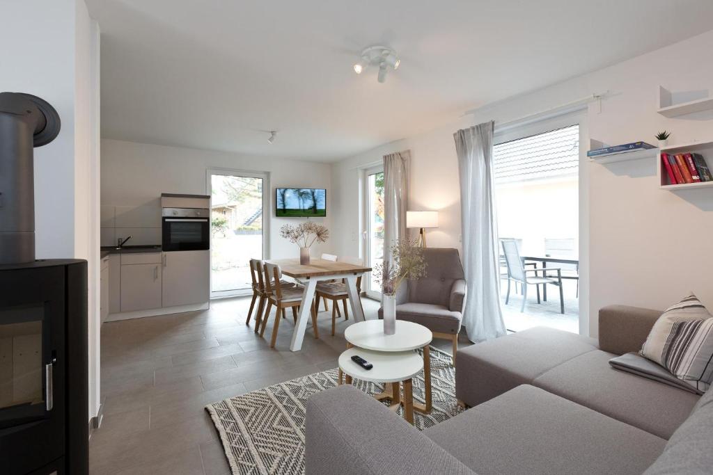 a living room with a couch and a table at Apartment unter den Kiefern 93 in Röbel