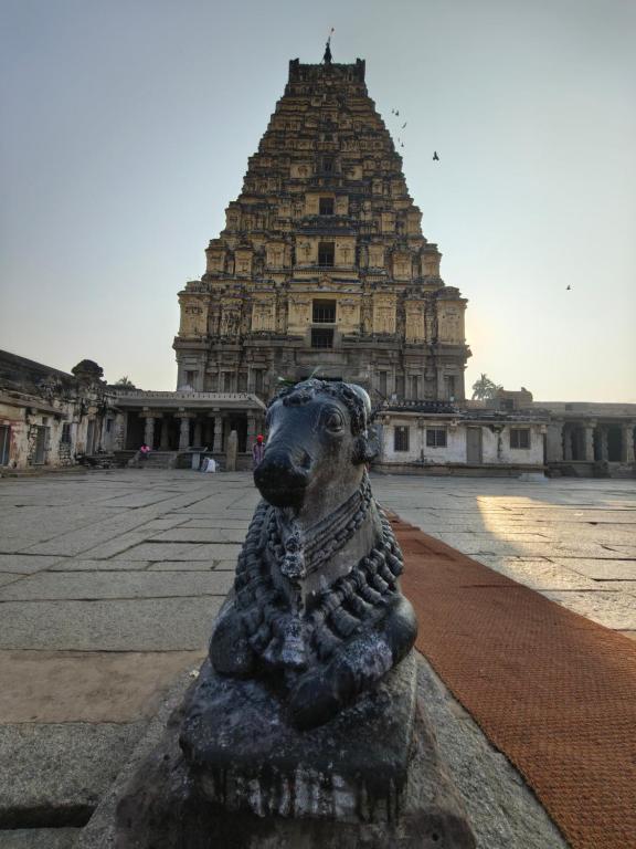 a statue of a dog in front of a building at Hamsa Home Stay in Hampi
