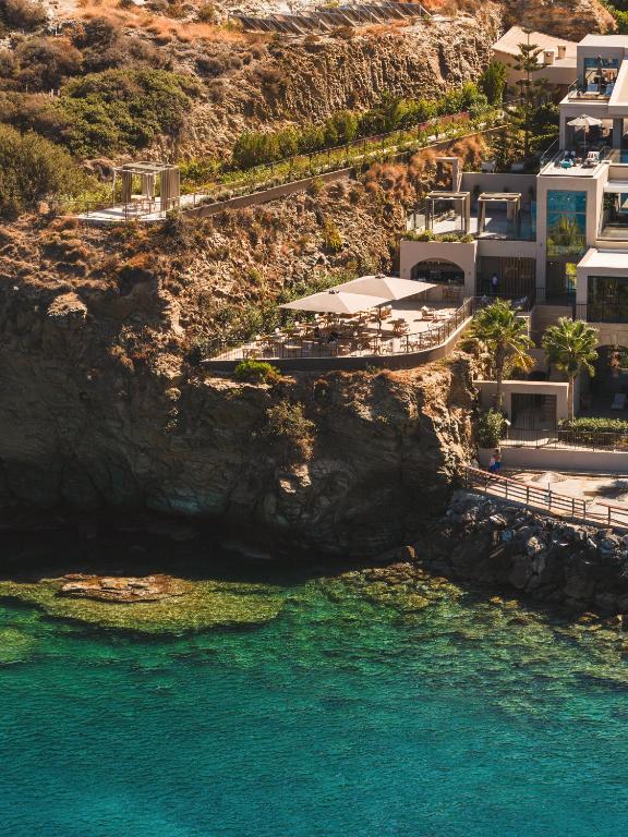 an aerial view of a resort with blue water at Castello Infinity Suites - Adults Only in Agia Pelagia