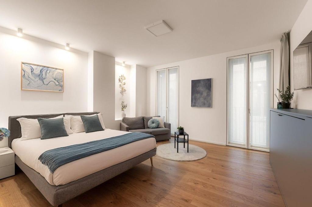 a bedroom with a bed and a couch in it at The Golden Studio by Aura Luxury Collection in Como