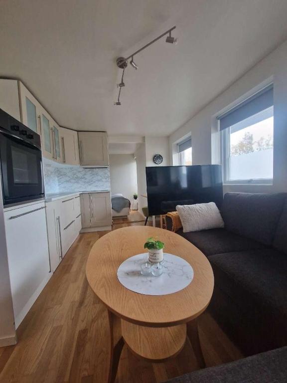 a living room with a table and a couch at Modern condominium in Bergen