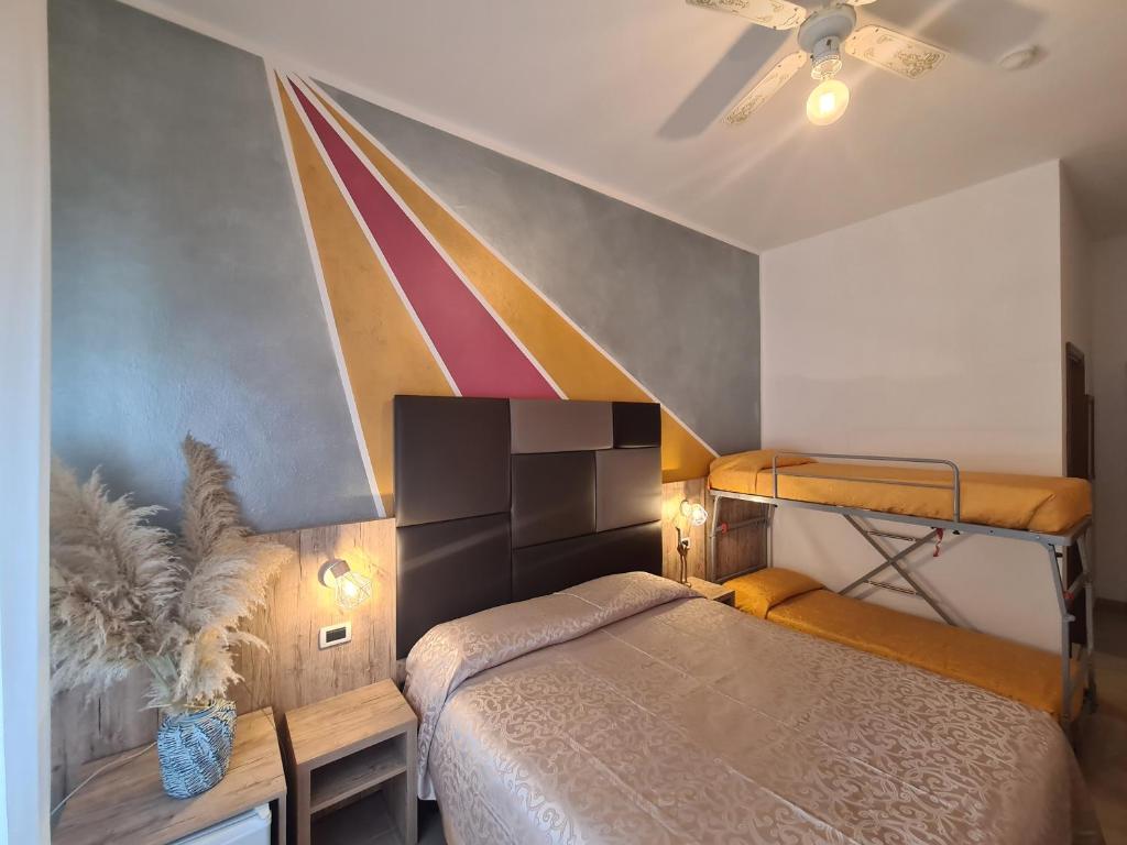 Ένα ή περισσότερα κρεβάτια σε δωμάτιο στο Hotel Gladys